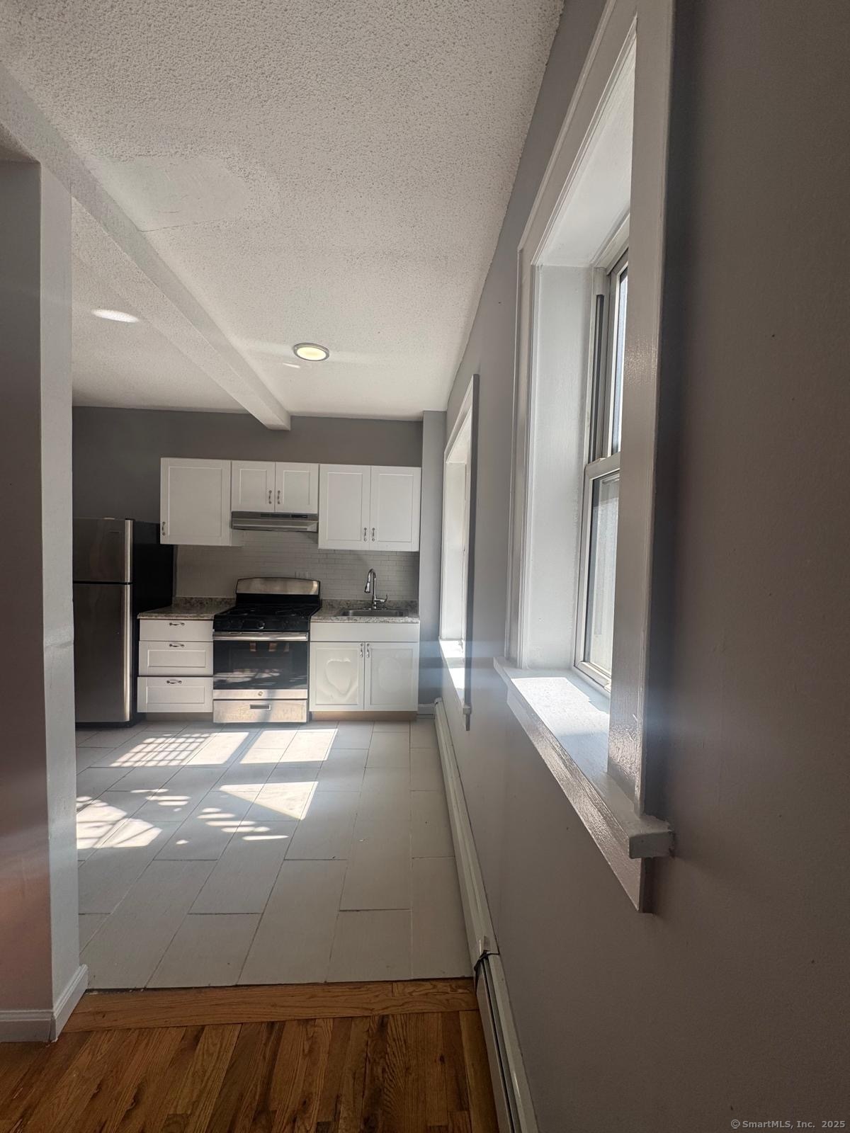 147 Charles Street, Unit 2D Bridgeport, CT 06606 - Photo 2 of 6 a view of kitchen with stainless steel appliances a refrigerator and microwave