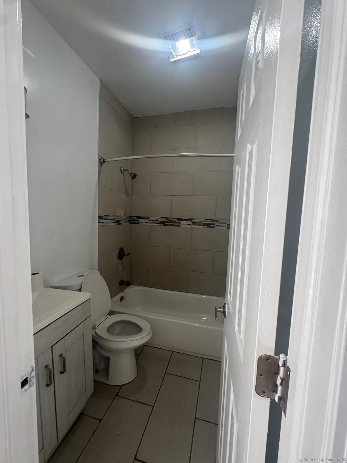 147 Charles Street, Unit 2D Bridgeport, CT 06606 - Photo 5 of 6 a bathroom with a toilet and a shower
