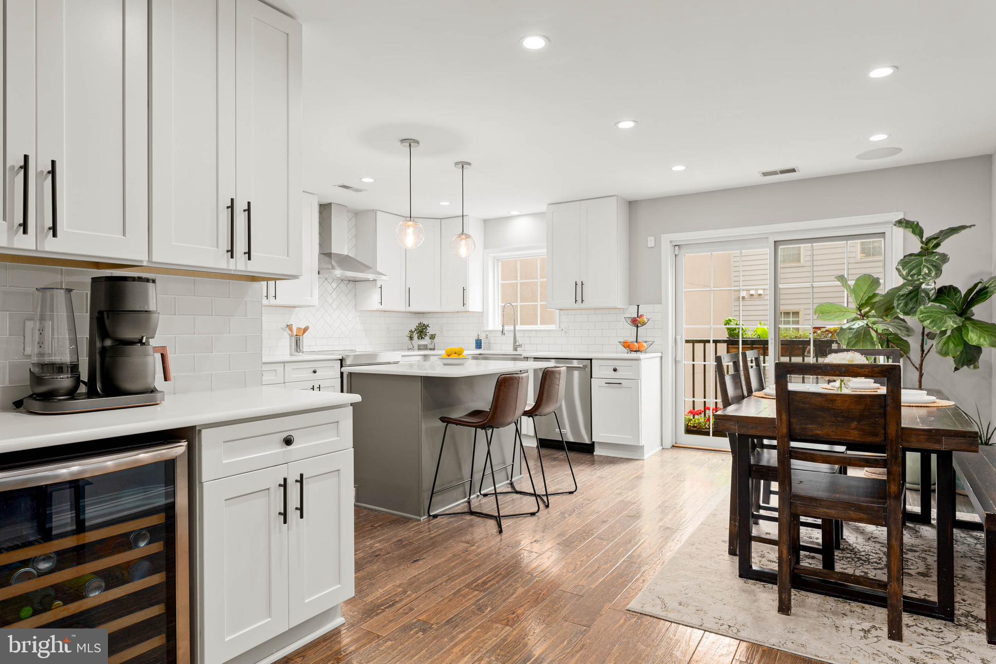 a open dining room with stainless steel appliances kitchen island granite countertop a dining table chairs and view kitchen