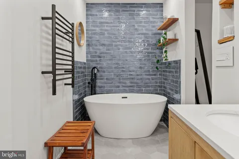 a room with furniture a rug and a painting on the wall