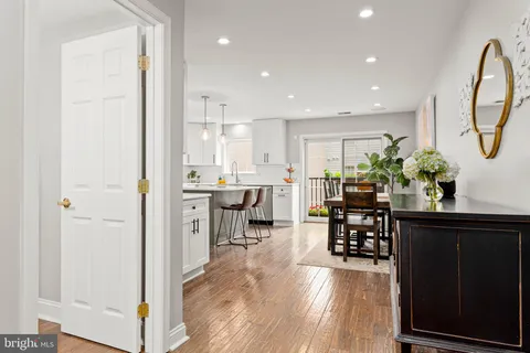 a kitchen with stainless steel appliances a stove a sink refrigerator and a wooden cabinets