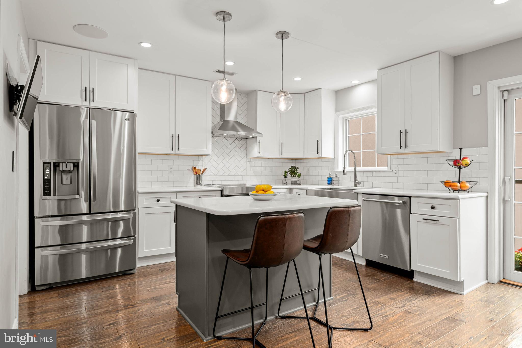 2330 Fairmount Avenue, Unit A Philadelphia, PA 19130 - Photo 8 of 34 a kitchen with stainless steel appliances a stove a sink refrigerator and a wooden cabinets