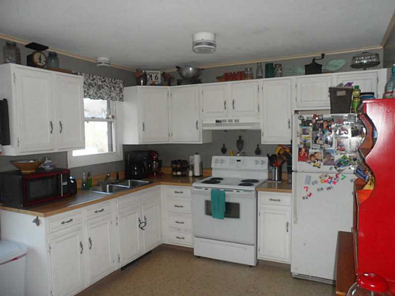 107 Wampum Road Narragansett, RI 02882 - Photo 8 of 19 Kitchen. The kitchen is modern and the cabinets have been recently painted. The slider to the deck is just to the left of this picture.