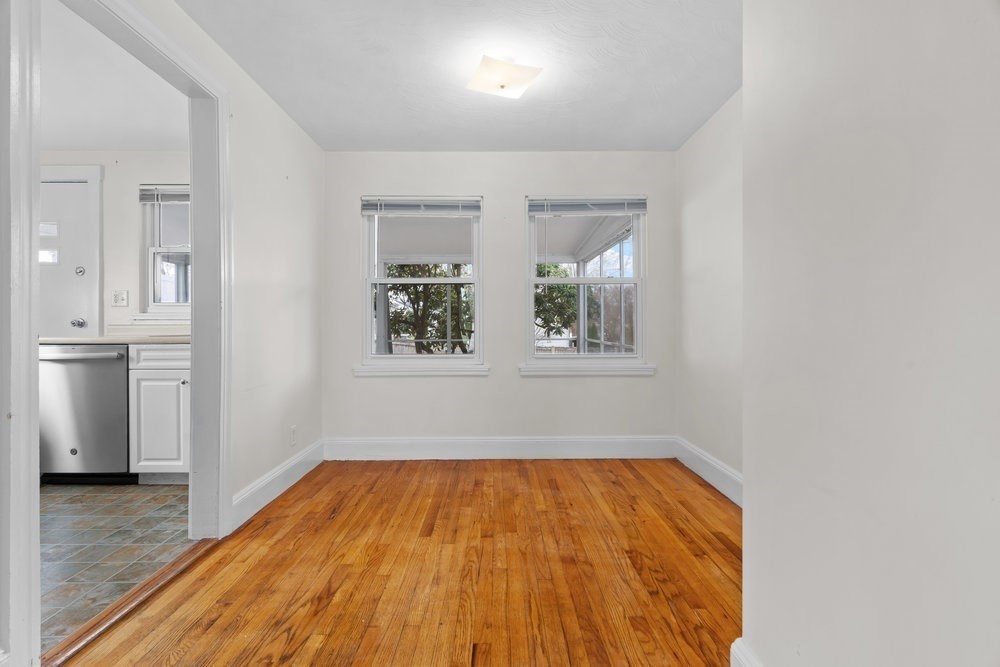 12 Pershing Road Newton, MA 02465 - Photo 11 of 29 a view of empty room with wooden floor and window