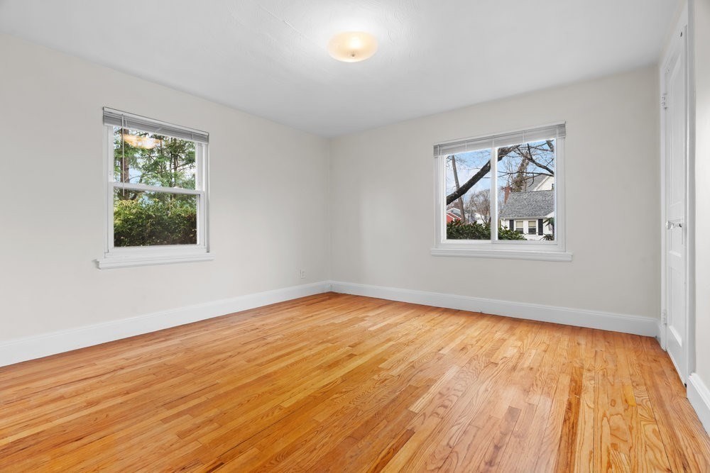 12 Pershing Road Newton, MA 02465 - Photo 14 of 29 a view of empty room with wooden floor and fan