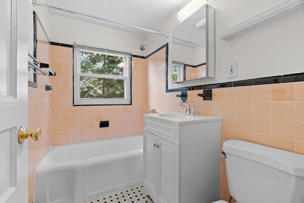 12 Pershing Road Newton, MA 02465 - Photo 15 of 29 a bathroom with a sink a toilet and shower