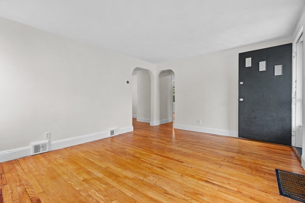 12 Pershing Road Newton, MA 02465 - Photo 6 of 29 a view of empty room with wooden floor