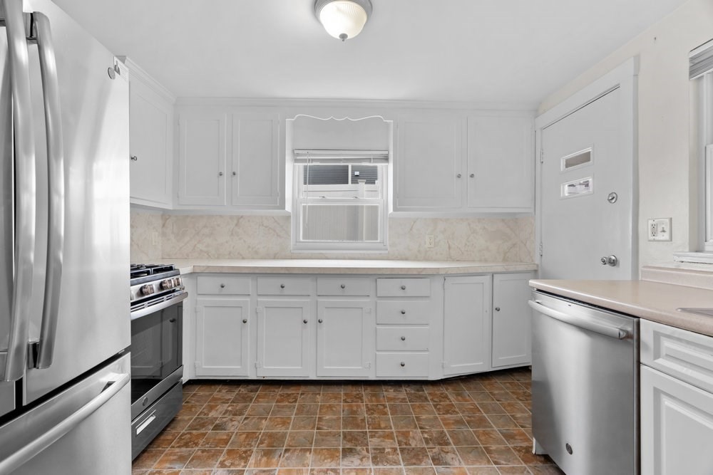 12 Pershing Road Newton, MA 02465 - Photo 7 of 29 a kitchen with white cabinets and appliances