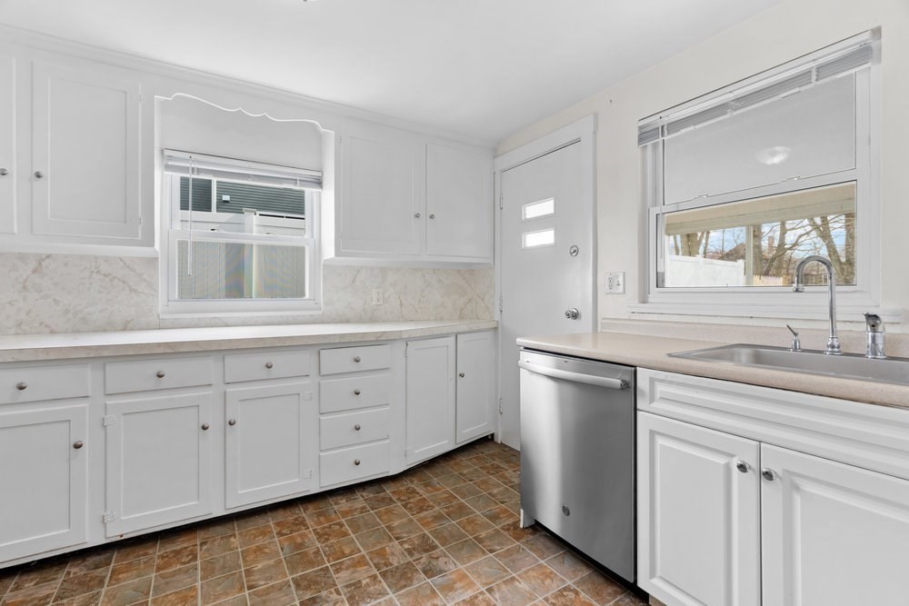 12 Pershing Road Newton, MA 02465 - Photo 9 of 29 a kitchen with a sink cabinets and stainless steel appliances