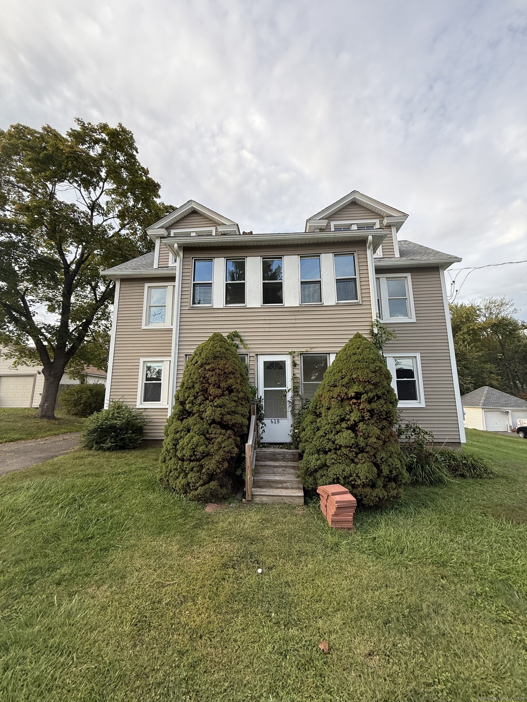a front view of a house with a yard and garage