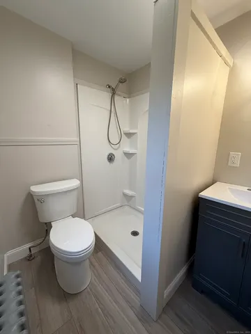 a bathroom with a toilet and a shower