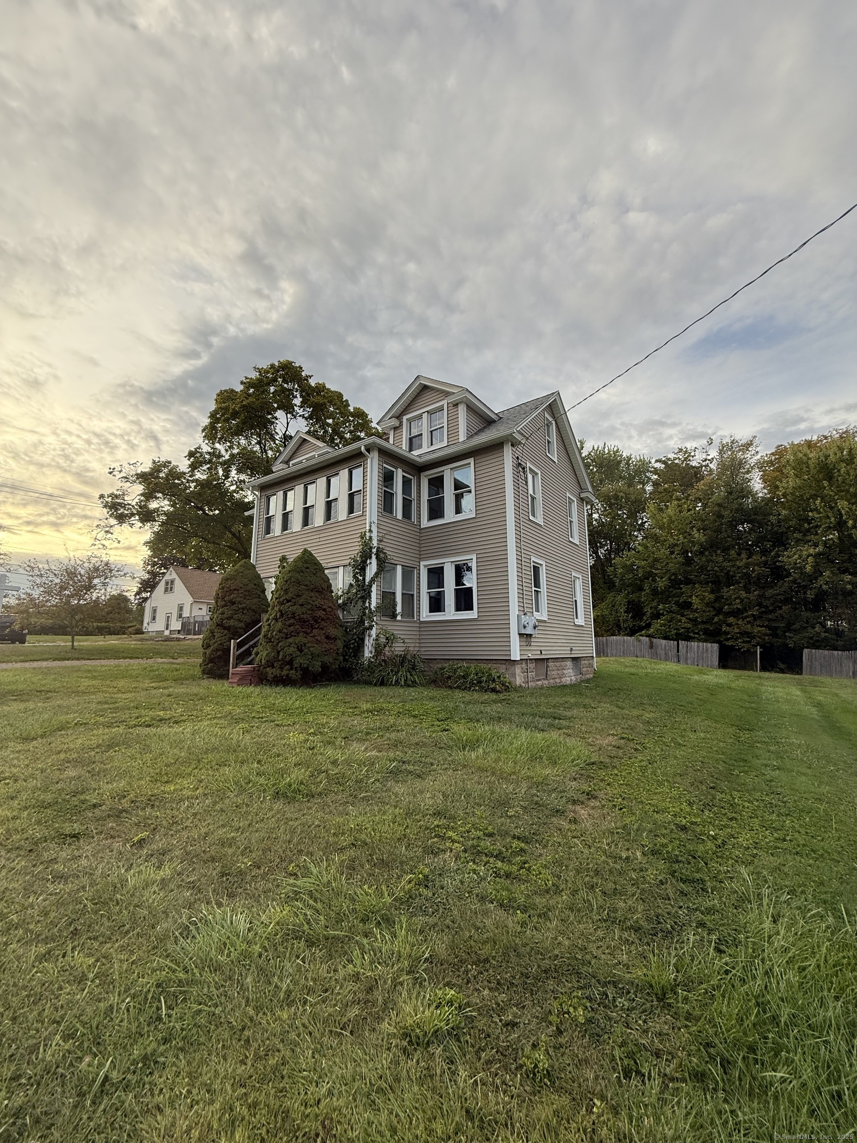 820 Burbank Avenue Suffield, CT 06078 - Photo 2 of 15 a view of a big house with a big yard and large trees