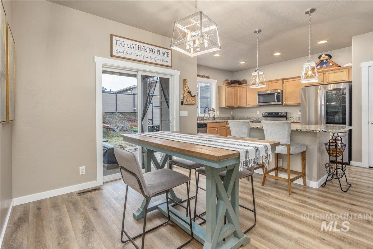 5668 West Old Ranch Street Boise, ID 83714 - Photo 19 of 44 Dining space with light wood-type flooring, recessed lighting, and a chandelier