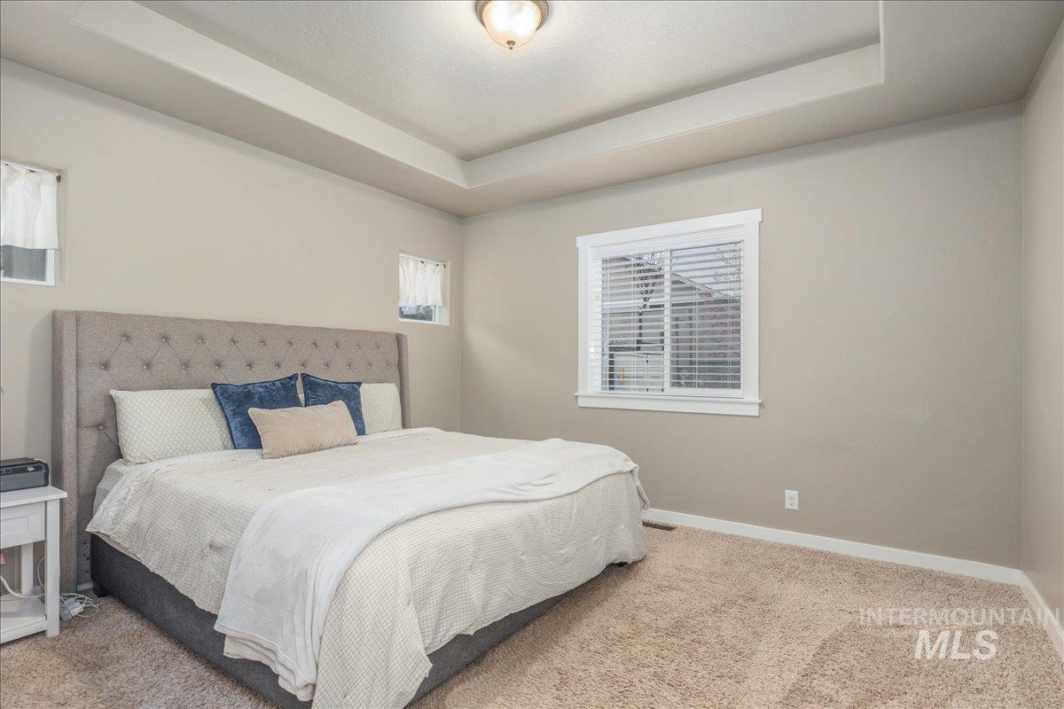 5668 West Old Ranch Street Boise, ID 83714 - Photo 24 of 44 Bedroom with a raised ceiling and carpet flooring