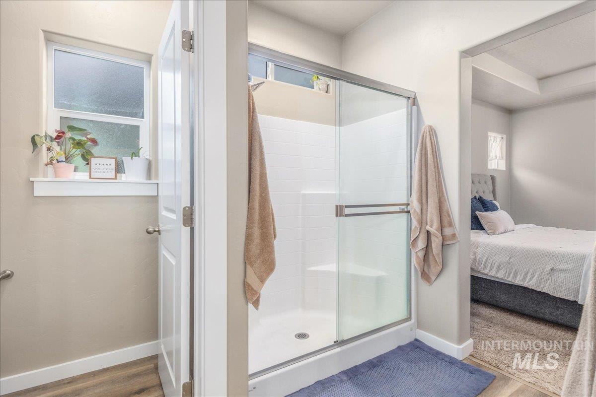 5668 West Old Ranch Street Boise, ID 83714 - Photo 27 of 44 Ensuite bathroom with a shower stall and wood finished floors