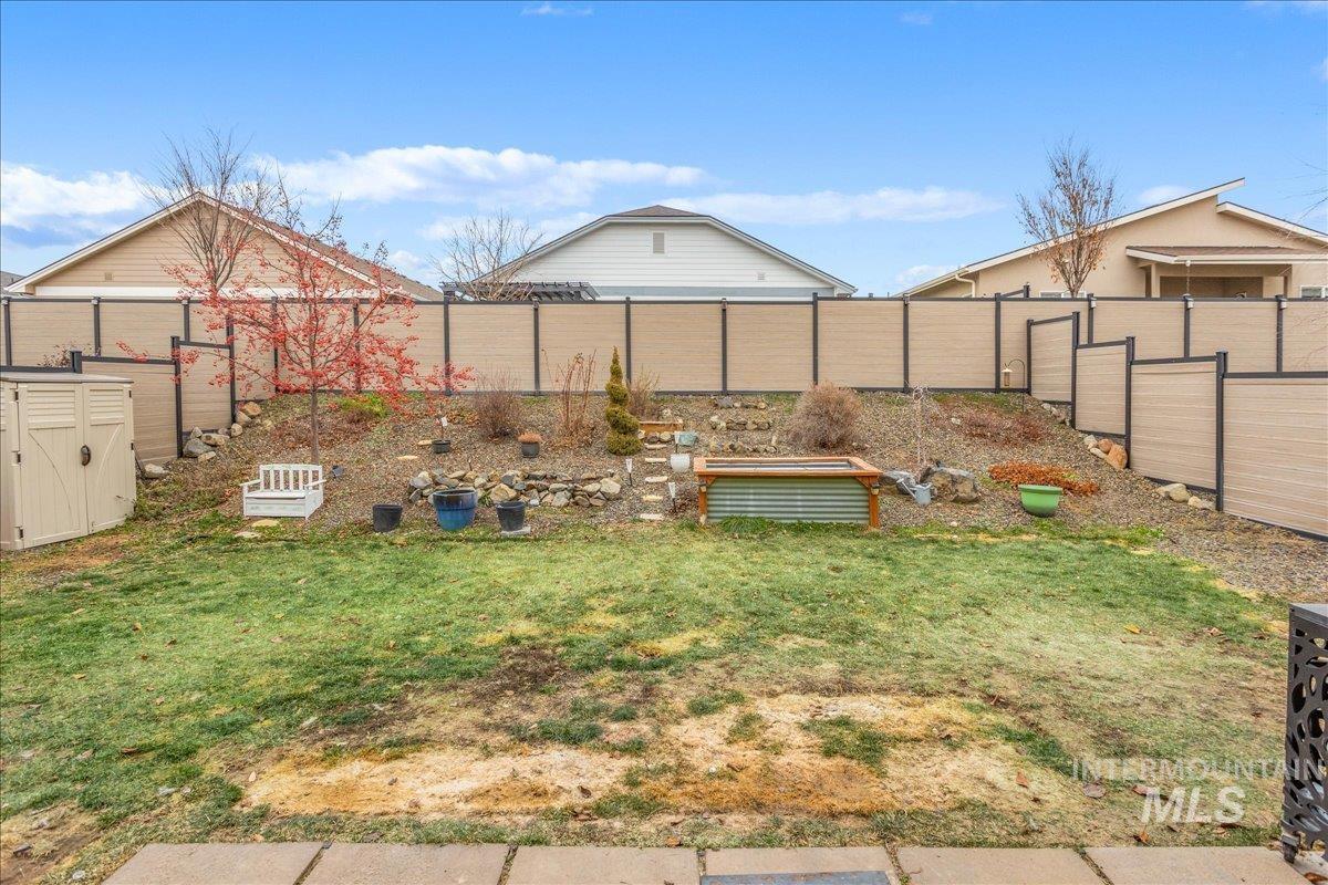 5668 West Old Ranch Street Boise, ID 83714 - Photo 37 of 44 Fenced backyard featuring a vegetable garden
