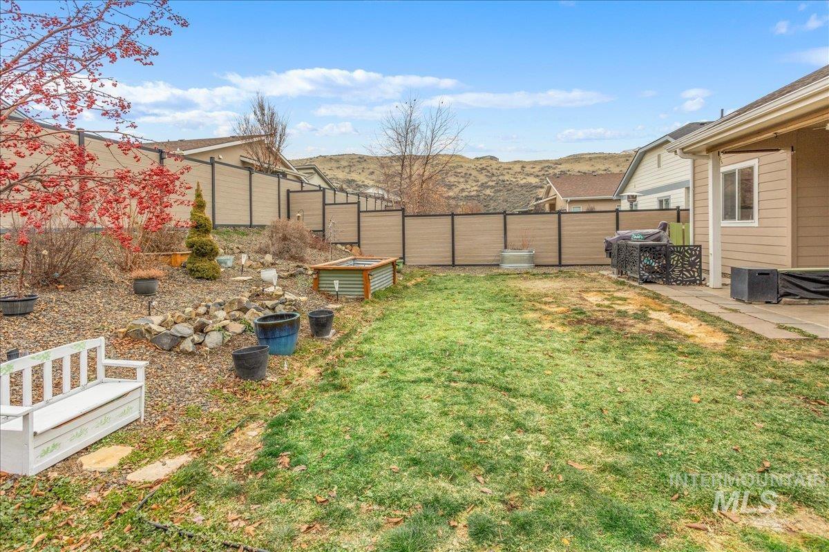 5668 West Old Ranch Street Boise, ID 83714 - Photo 38 of 44 Fenced backyard featuring a patio area and a mountain view