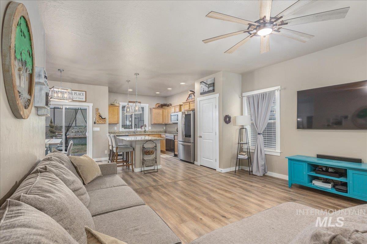 5668 West Old Ranch Street Boise, ID 83714 - Photo 10 of 44 Living area with light wood finished floors, recessed lighting, ceiling fan, and a chandelier