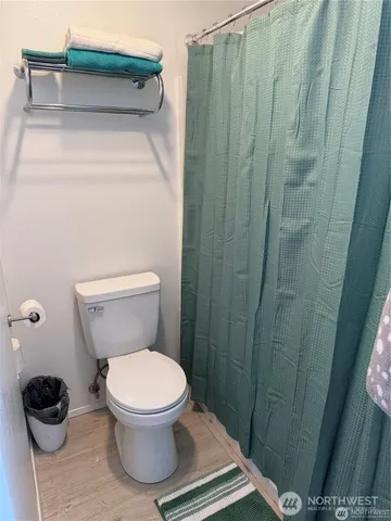 a bathroom with a toilet and a shower