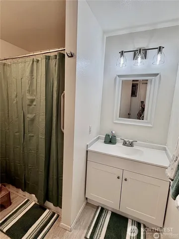 a bathroom with a sink a mirror a vanity and a toilet