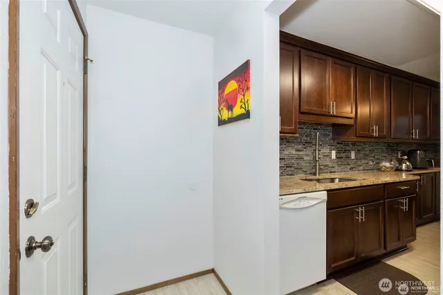 a kitchen with granite countertop stainless steel appliances and wooden cabinets
