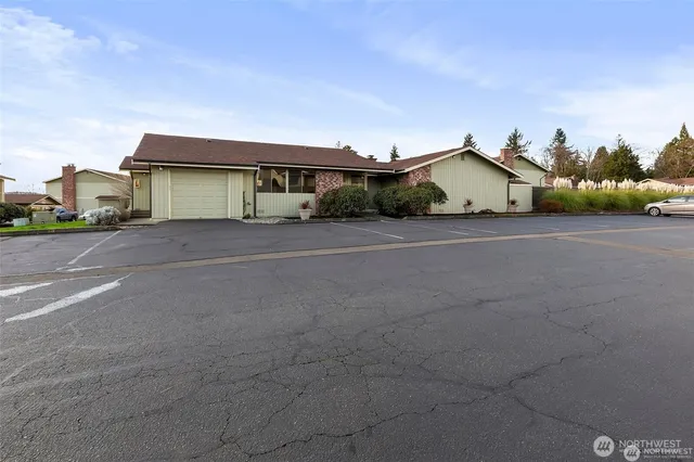 a view of a house with a yard and garage