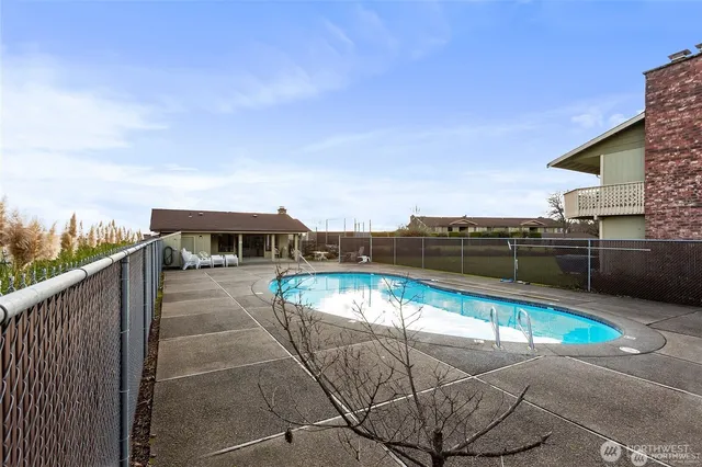 a view of a swimming pool with a lounge chair