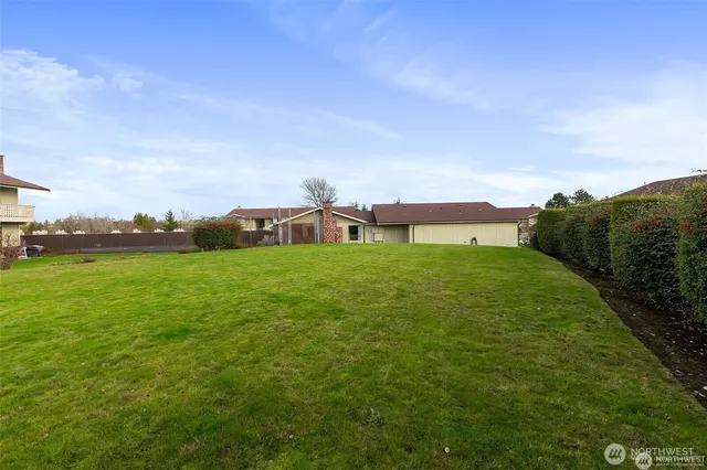 a view of green field with house in the background