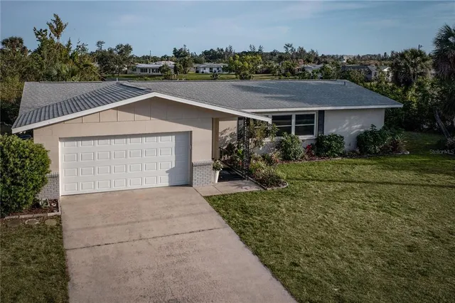 a front view of a house with a yard and trees