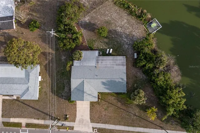 an aerial view of a house with a yard