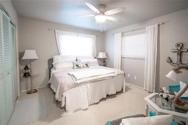 a spacious bedroom with a bed and a chandelier