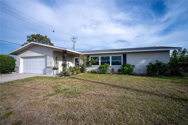 a front view of house with yard and green space