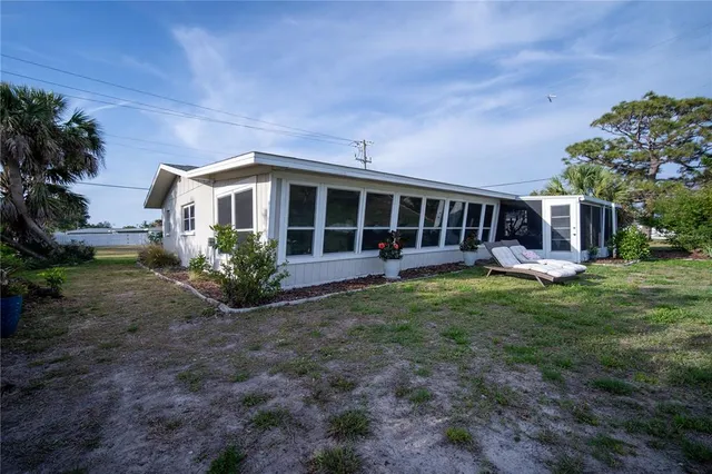 a view of a house with backyard and porch