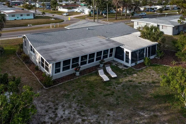 an aerial view of a house with a yard