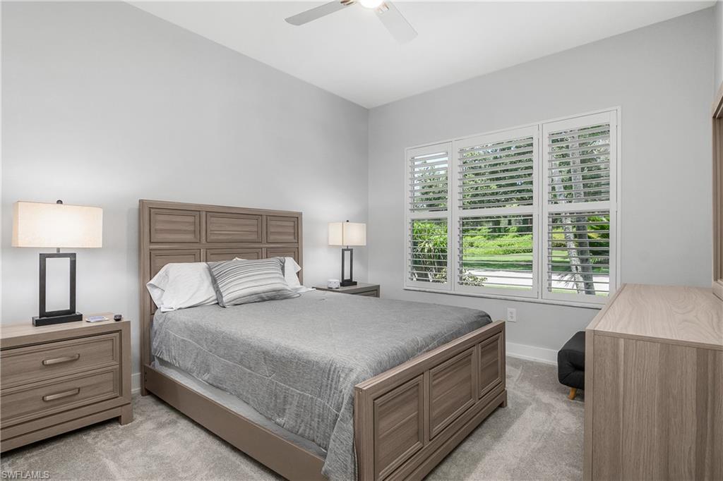 24361 Copperleaf Boulevard Estero, FL 34135 - Photo 20 of 49 a bedroom with a bed and a lamp on dresser