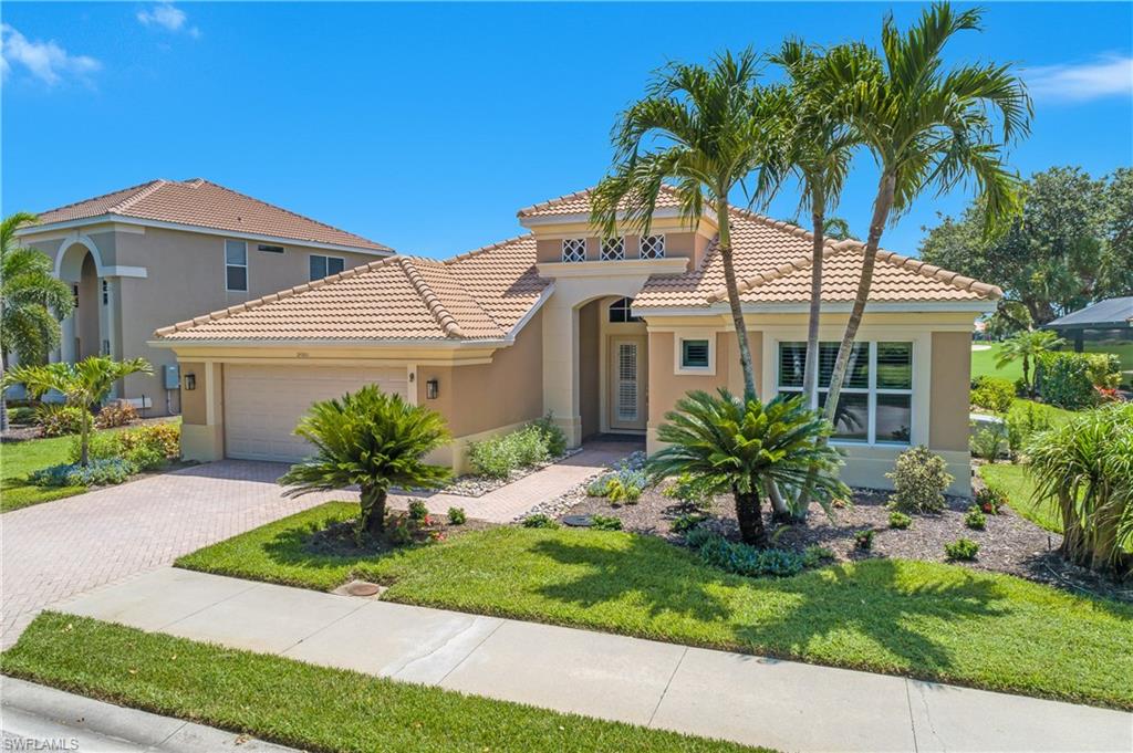 24361 Copperleaf Boulevard Estero, FL 34135 - Photo 2 of 49 a front view of a house with a garden