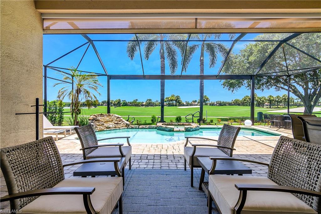 24361 Copperleaf Boulevard Estero, FL 34135 - Photo 26 of 49 a view of chairs and table in patio with a small yard