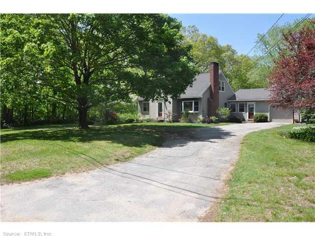 a view of house with yard and green space
