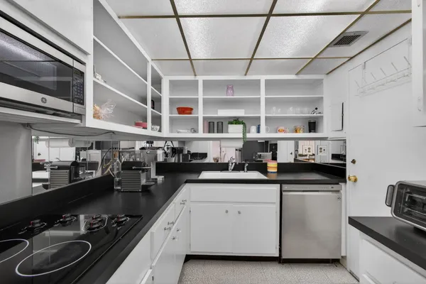 a kitchen with a sink appliances and cabinets
