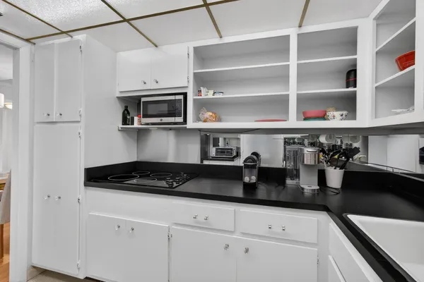a kitchen with stainless steel appliances granite countertop a sink a stove and cabinets