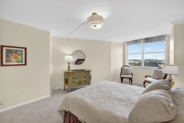 a bedroom with a bed and window