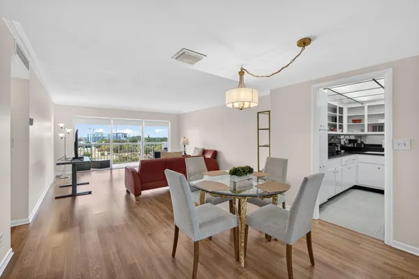 a dining room with furniture a window and wooden floor