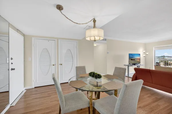 a view of a dining room with furniture and wooden floor