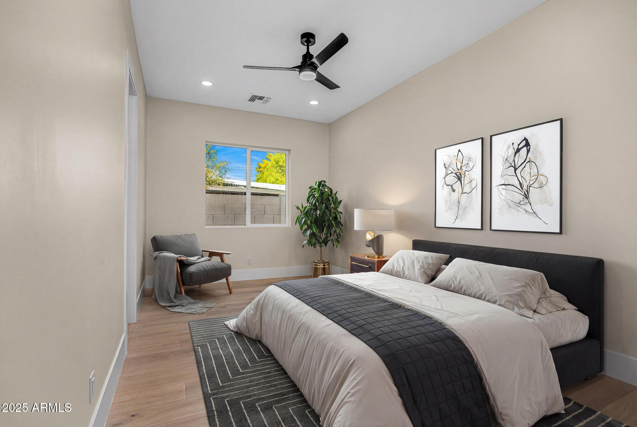 3002 North 53rd Place Phoenix, AZ 85018 - Photo 15 of 19 a bedroom with a bed and a tv