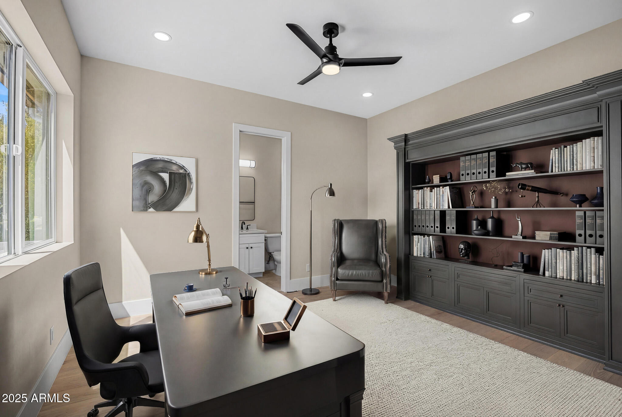 3002 North 53rd Place Phoenix, AZ 85018 - Photo 18 of 19 a living room with furniture and a book shelf