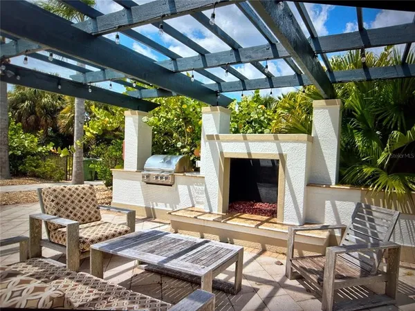 a view of a patio with lawn chairs wooden floor and dining table