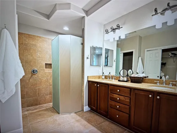 a kitchen with stainless steel appliances granite countertop a stove a sink a refrigerator dining table and chairs