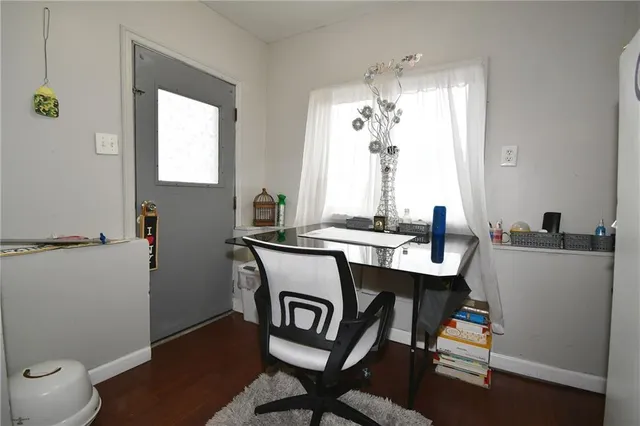 a bedroom with a bed couch and a large window