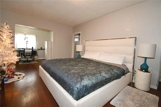 a bed room with a bed and a chair