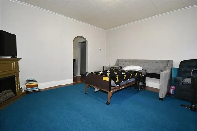 a bedroom with a bed and a television